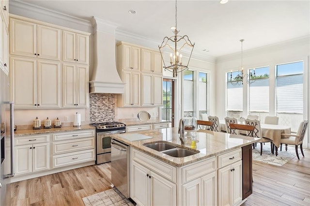 kitchen with stainless steel appliances, an inviting chandelier, sink, premium range hood, and backsplash