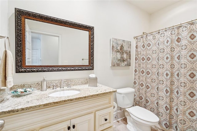 bathroom with vanity, tile patterned flooring, and toilet