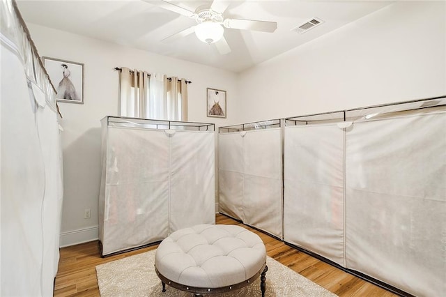 walk in closet featuring ceiling fan and light wood-type flooring