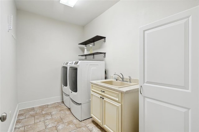 laundry area featuring light tile patterned flooring, sink, independent washer and dryer, and cabinets