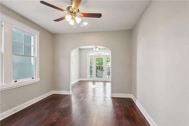 unfurnished room featuring french doors, ceiling fan, and dark hardwood / wood-style floors