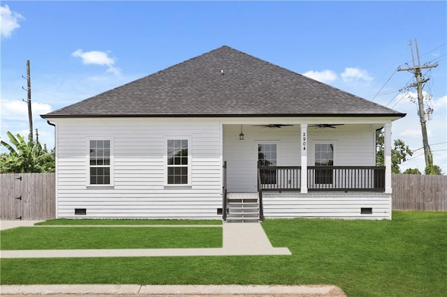 rear view of property featuring covered porch, a lawn, and ceiling fan