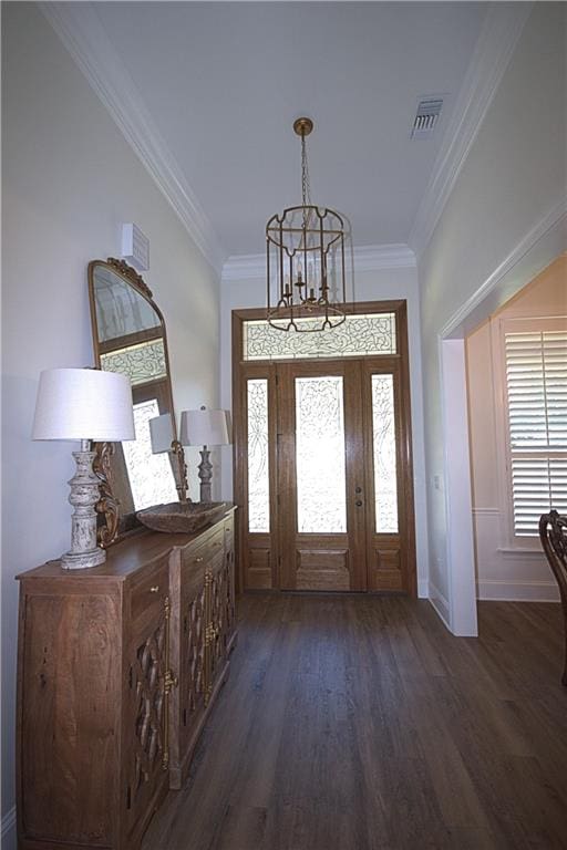 entrance foyer featuring dark hardwood / wood-style floors, a notable chandelier, and crown molding