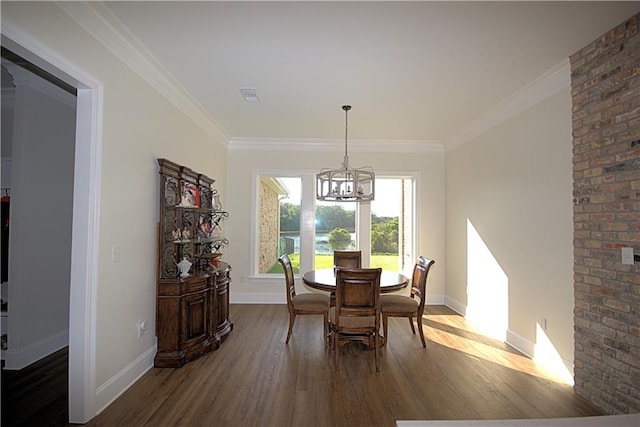 dining area with brick wall, ornamental molding, hardwood / wood-style flooring, and a notable chandelier