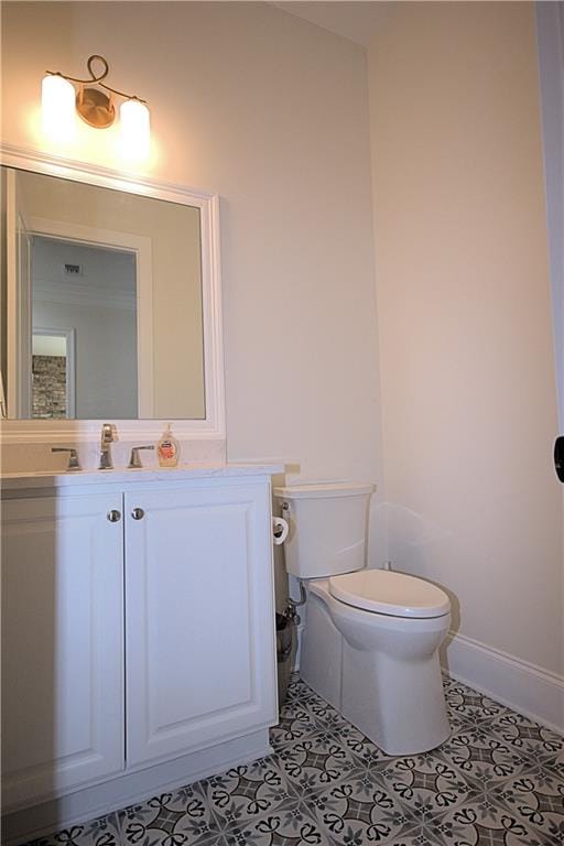 bathroom featuring tile patterned flooring, toilet, and vanity