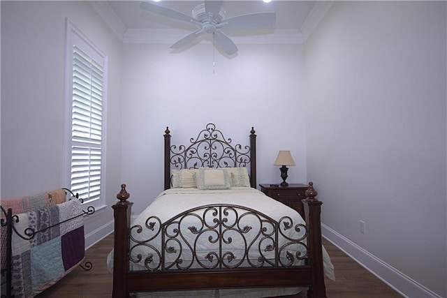 bedroom with crown molding, dark wood-type flooring, and ceiling fan