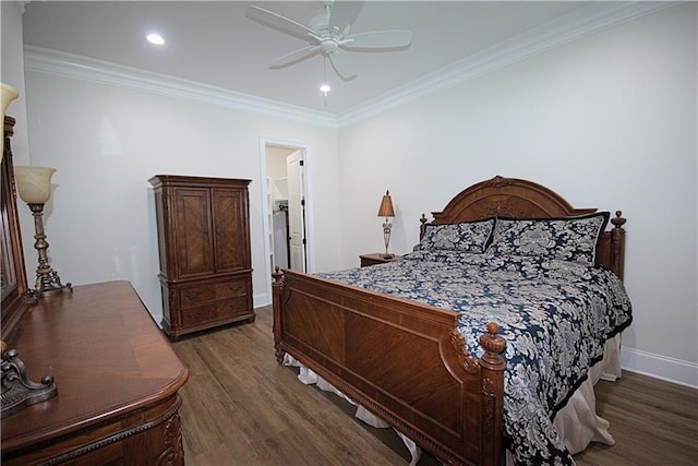 bedroom featuring ceiling fan, crown molding, dark hardwood / wood-style flooring, and connected bathroom