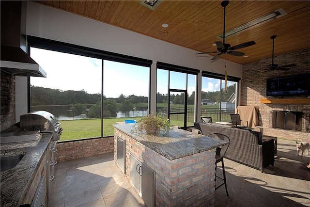 view of patio / terrace with a grill, a bar, area for grilling, and ceiling fan