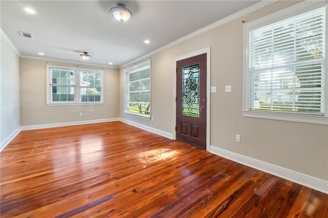 foyer entrance with hardwood / wood-style flooring and ornamental molding