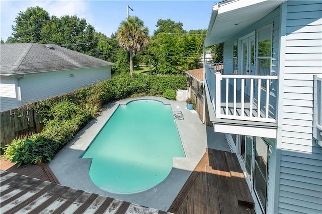 view of swimming pool with a deck