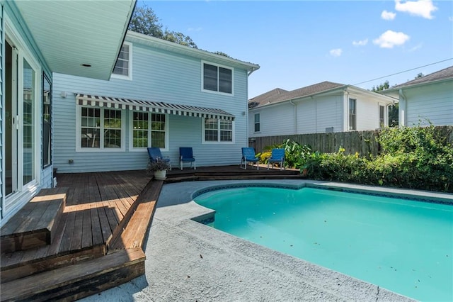 view of swimming pool with a wooden deck