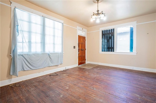 foyer entrance featuring a chandelier and wood-type flooring