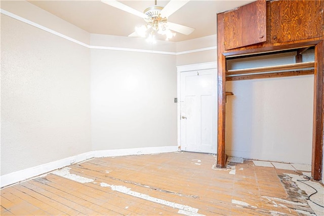 unfurnished bedroom with ceiling fan, light hardwood / wood-style flooring, and a closet