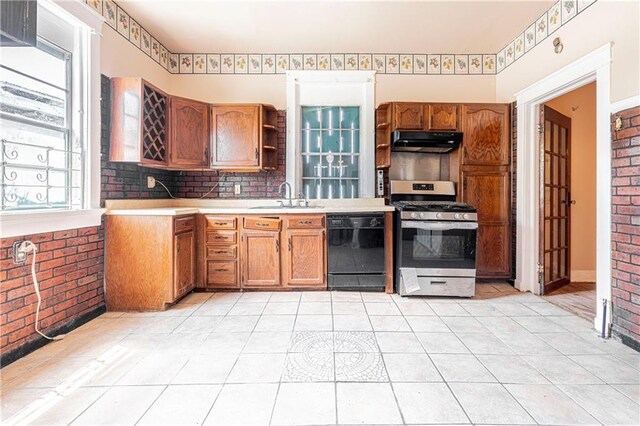 kitchen with stainless steel range with gas stovetop, light tile patterned flooring, sink, dishwasher, and range hood