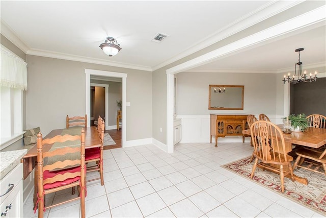 dining room with ornamental molding, light tile patterned floors, and a chandelier