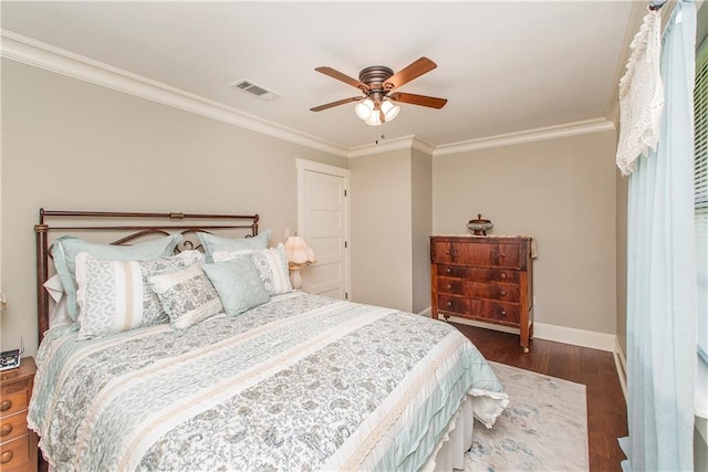 bedroom featuring dark wood-type flooring, ceiling fan, and ornamental molding