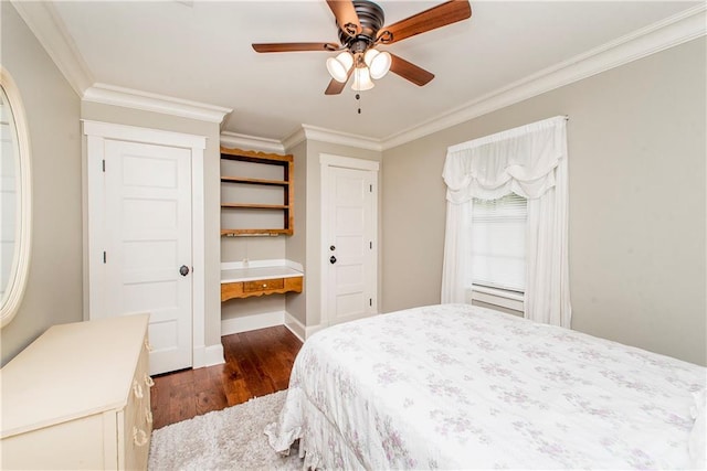 bedroom featuring ceiling fan, crown molding, and dark wood-type flooring