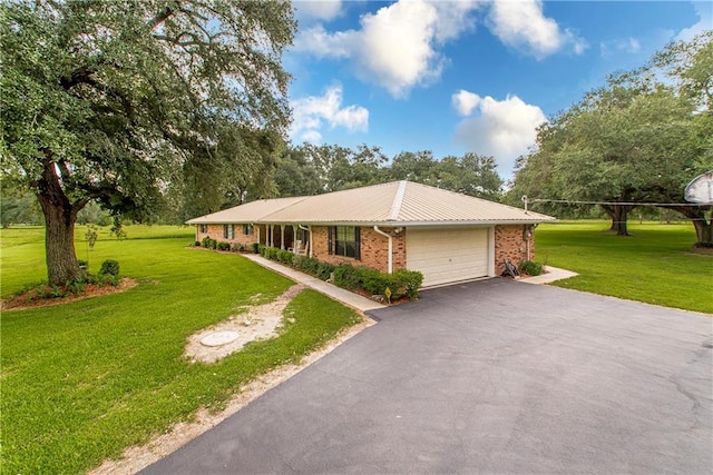 single story home with a garage and a front yard