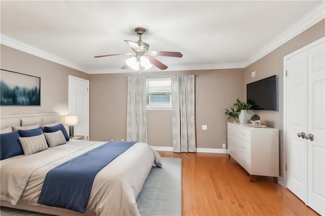 bedroom with ceiling fan, crown molding, and light wood-type flooring