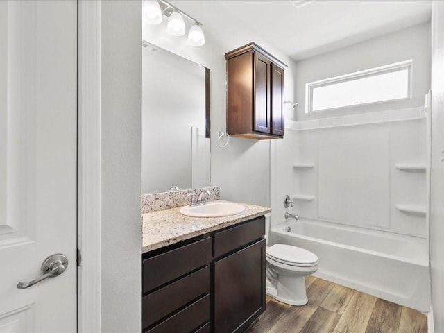 full bathroom featuring vanity, toilet, tub / shower combination, and hardwood / wood-style flooring