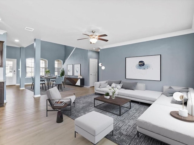 living room with crown molding, wood-type flooring, and ceiling fan