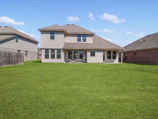 rear view of house featuring a yard and a patio area