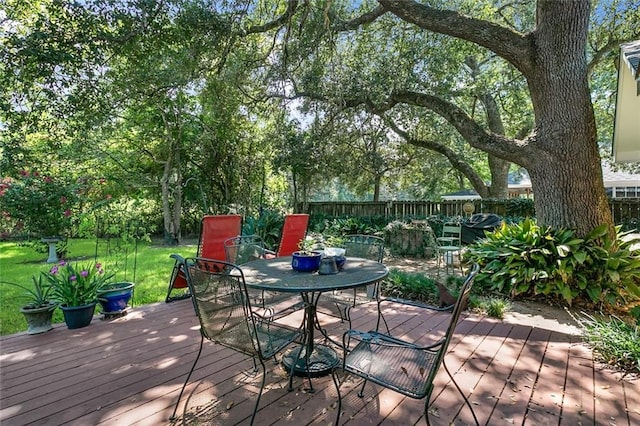 wooden deck featuring a lawn