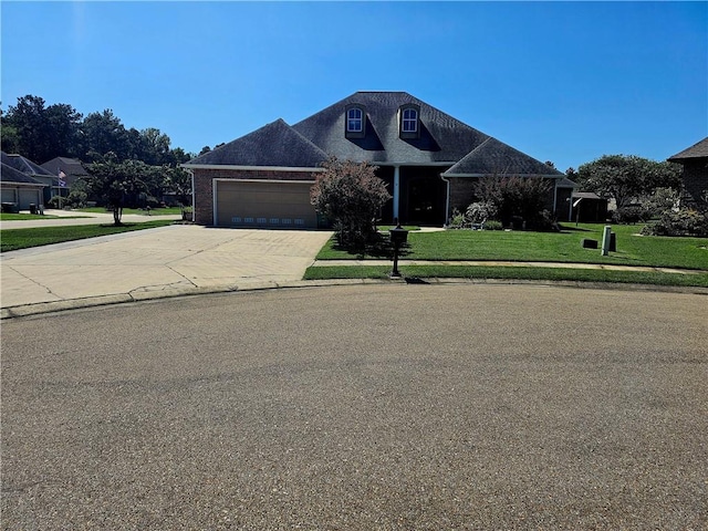 view of front of house with a front yard and a garage