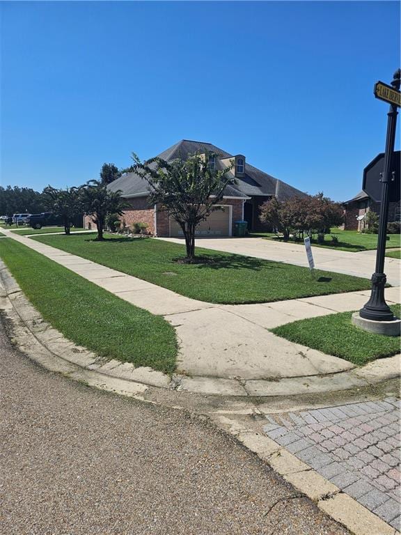 exterior space featuring a garage and a lawn