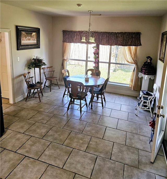 669 Lake Iberville Ct, Ponchatoula, LA 70454 - dining room with a chandelier and tile patterned floors