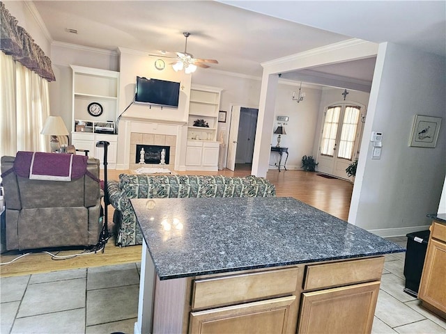 669 Lake Iberville Ct, Ponchatoula, LA 70454 - kitchen with open floor plan, ornamental molding, a ceiling fan, dark stone countertops, and baseboards