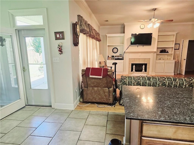669 Lake Iberville Ct, Ponchatoula, LA 70454 - living room featuring ornamental molding, a ceiling fan, light tile patterned flooring, and baseboards