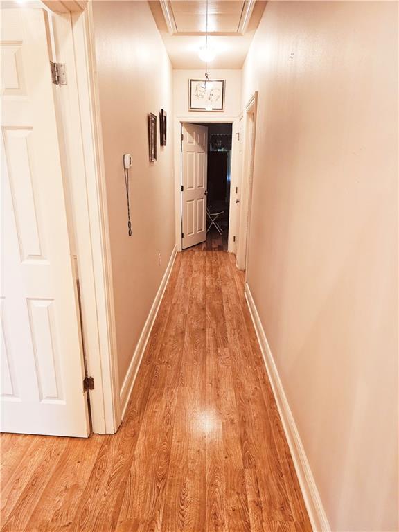 669 Lake Iberville Ct, Ponchatoula, LA 70454 - hall with attic access, light wood-type flooring, and baseboards