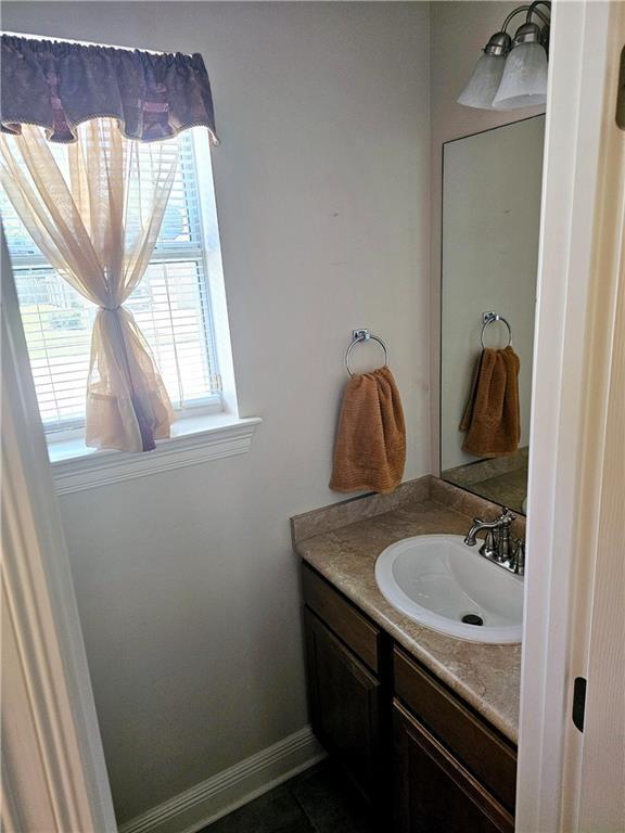 669 Lake Iberville Ct, Ponchatoula, LA 70454 - bathroom with vanity and baseboards