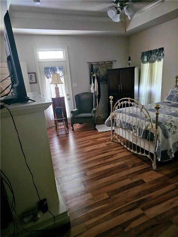669 Lake Iberville Ct, Ponchatoula, LA 70454 - bedroom with dark wood-type flooring and multiple windows