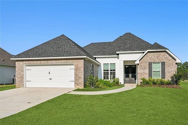 view of front facade featuring a garage, a front yard, and french doors