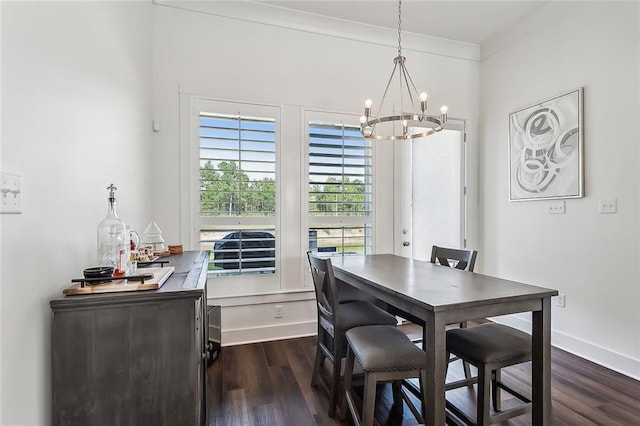 dining space featuring an inviting chandelier, crown molding, and dark hardwood / wood-style floors