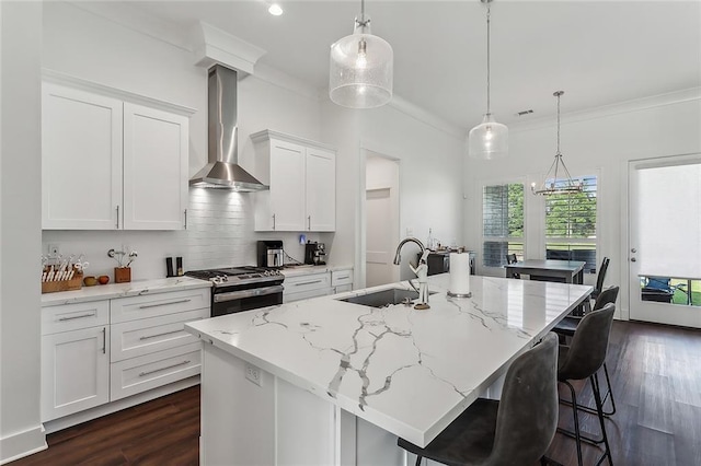 kitchen featuring sink, dark hardwood / wood-style flooring, gas stove, and wall chimney exhaust hood