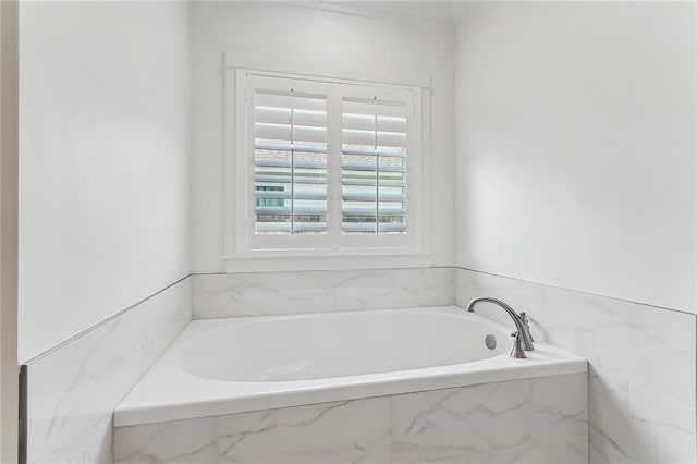 bathroom with tiled bath