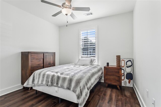 bedroom with dark hardwood / wood-style floors and ceiling fan