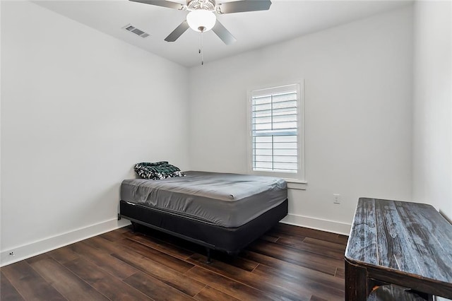 bedroom with dark hardwood / wood-style flooring and ceiling fan