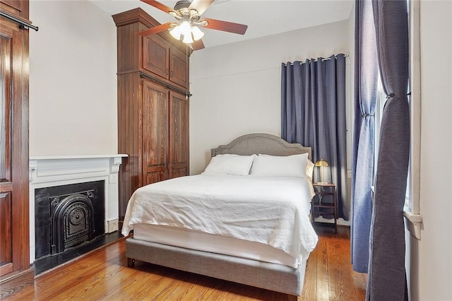 bedroom with ceiling fan and light wood-type flooring