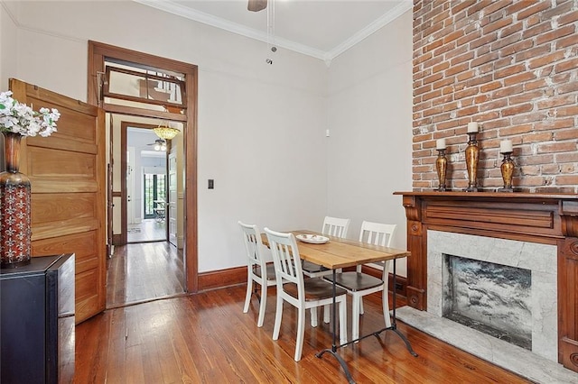 dining area featuring crown molding, ceiling fan, and wood-type flooring