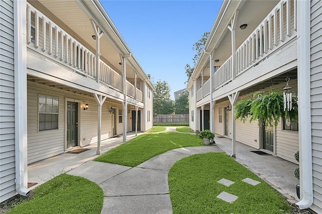 surrounding community with a patio and a yard