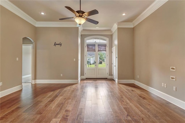 interior space with ceiling fan, french doors, ornamental molding, and hardwood / wood-style flooring