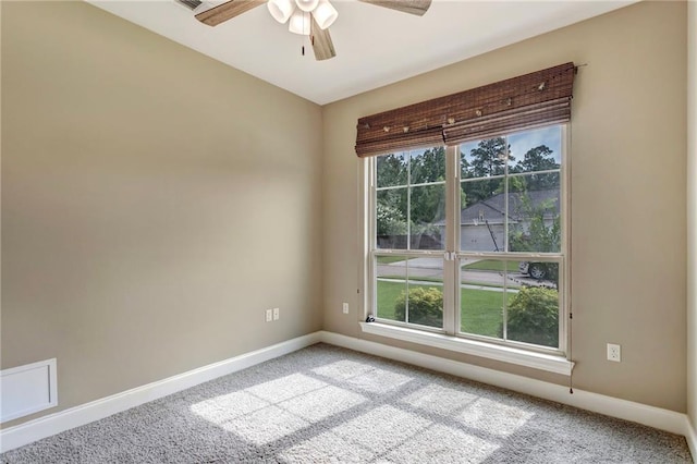 empty room with ceiling fan, baseboards, and light colored carpet