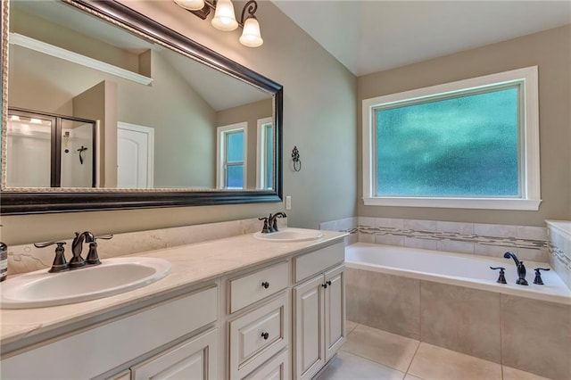 bathroom with dual bowl vanity, tile patterned floors, vaulted ceiling, and separate shower and tub