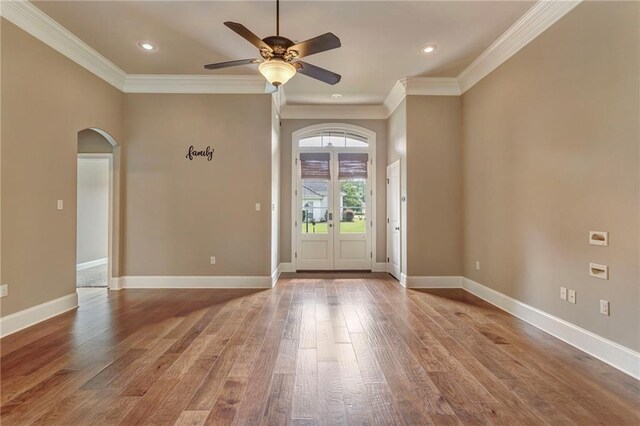 interior space with french doors, ornamental molding, hardwood / wood-style floors, and ceiling fan