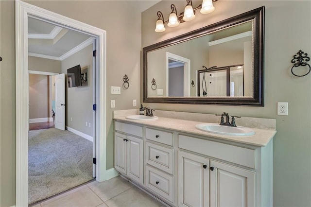 bathroom featuring dual bowl vanity, crown molding, and tile patterned flooring