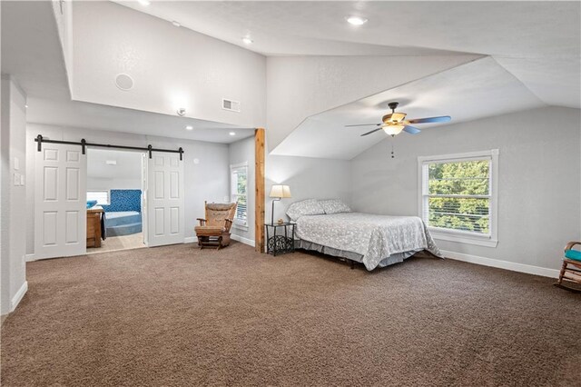 carpeted bedroom featuring ceiling fan, a barn door, and lofted ceiling